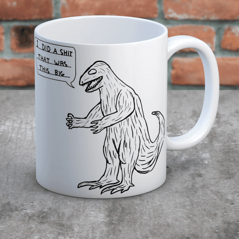 David Shrigley dinosaur mug on table with I did a shit that was this big illustration