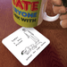 David Shrigley Sorry I Fell Asleep coaster shown under a mug on a table