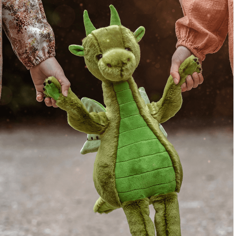 Deck green dragon teddy from Bearhouse by Charlie Bears 2025 held by hands, showing long arms, wings and green tummy panels