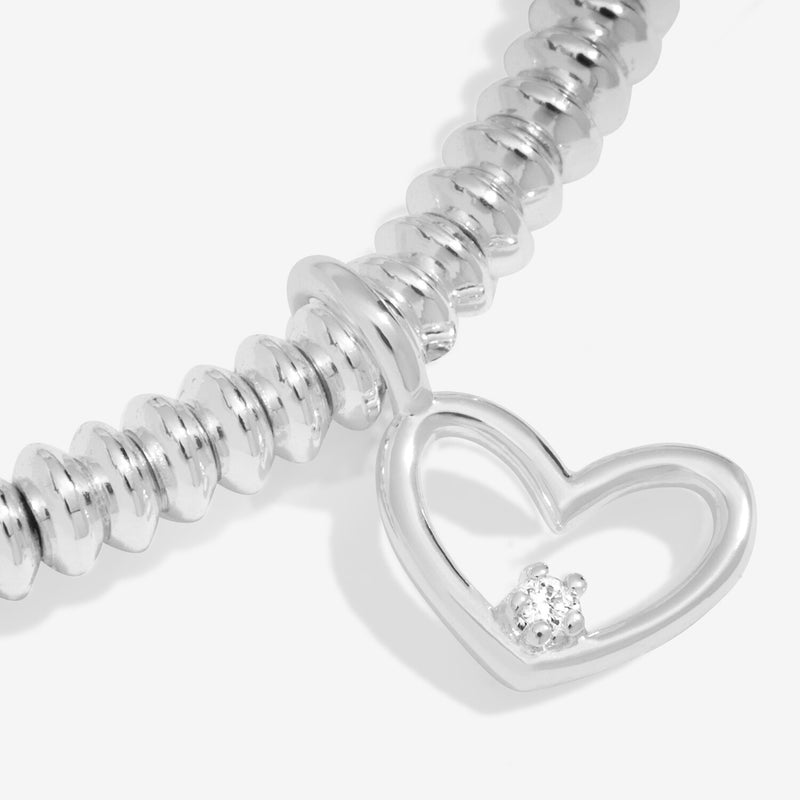 “Macro detail of lab‑grown diamond set in open‑heart charm”
