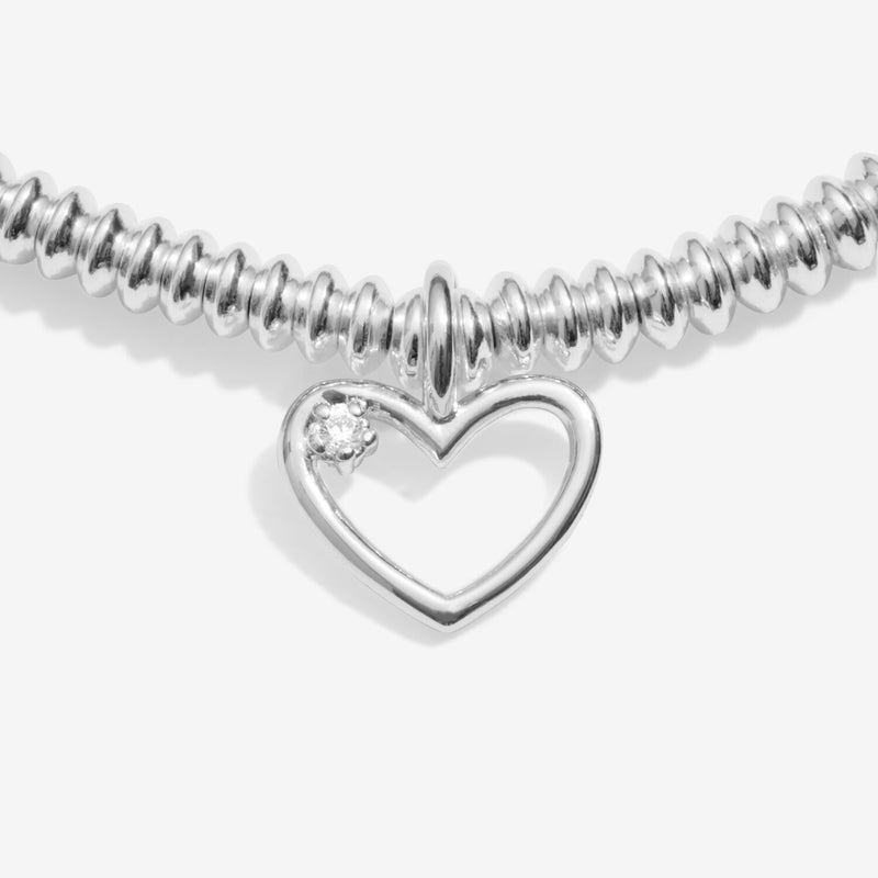 Close‑up of open‑heart charm featuring sparkling lab‑grown diamond