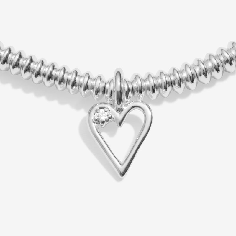 Close‑up of diamond‑set open‑heart charm on 40th birthday bracelet