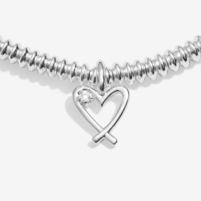 “Close‑up of open heart charm set with lab‑grown diamond on bracelet”
