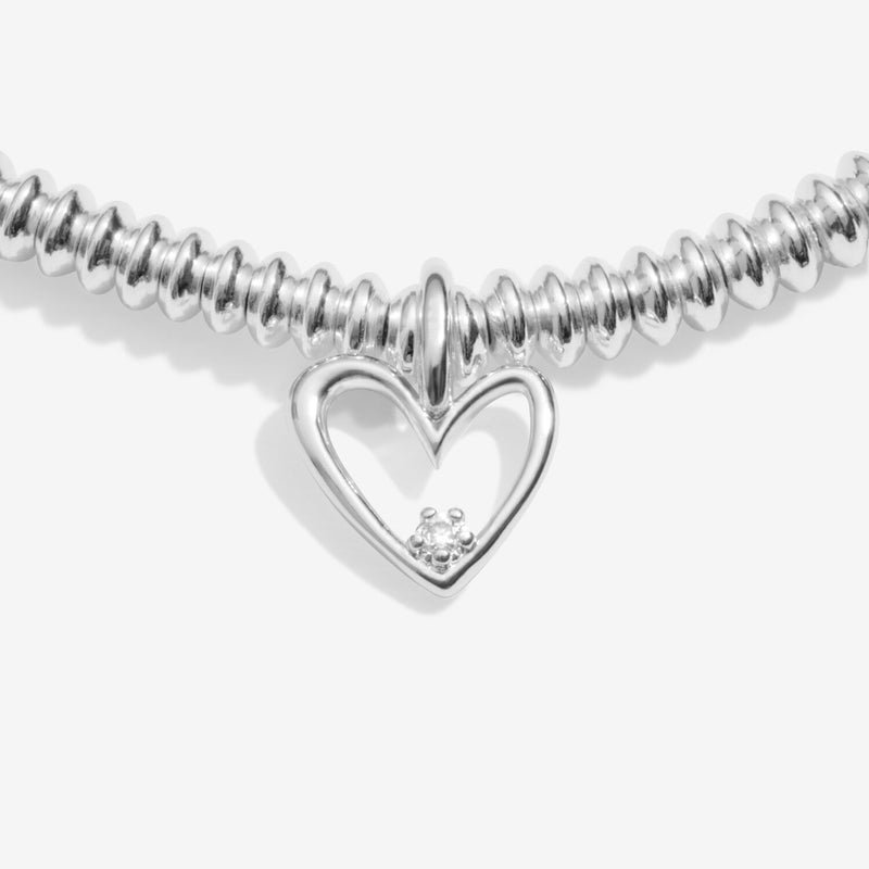 “Close‑up of open heart charm showing lab‑grown diamond on beaded bracelet”
