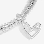“Macro view of lab‑grown diamond in open‑heart charm”
