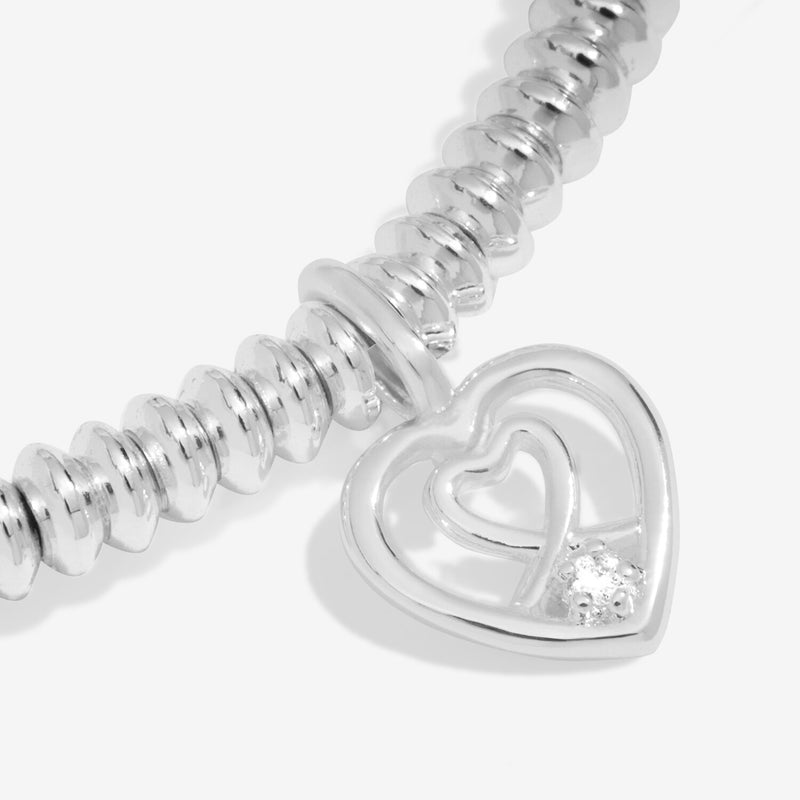 “Macro detail of diamond set in double‑heart charm – Wonderful Daughter bracelet”
