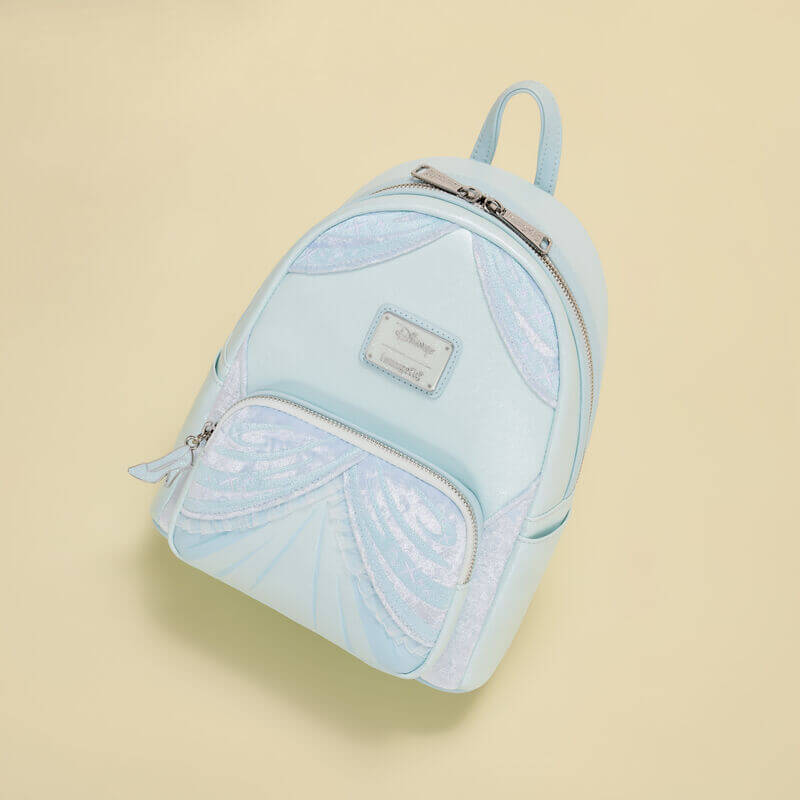 Light blue Cinderella Loungefly Back Pack bag with glittery draped dress panels, flat‑lay on cream backdrop.	