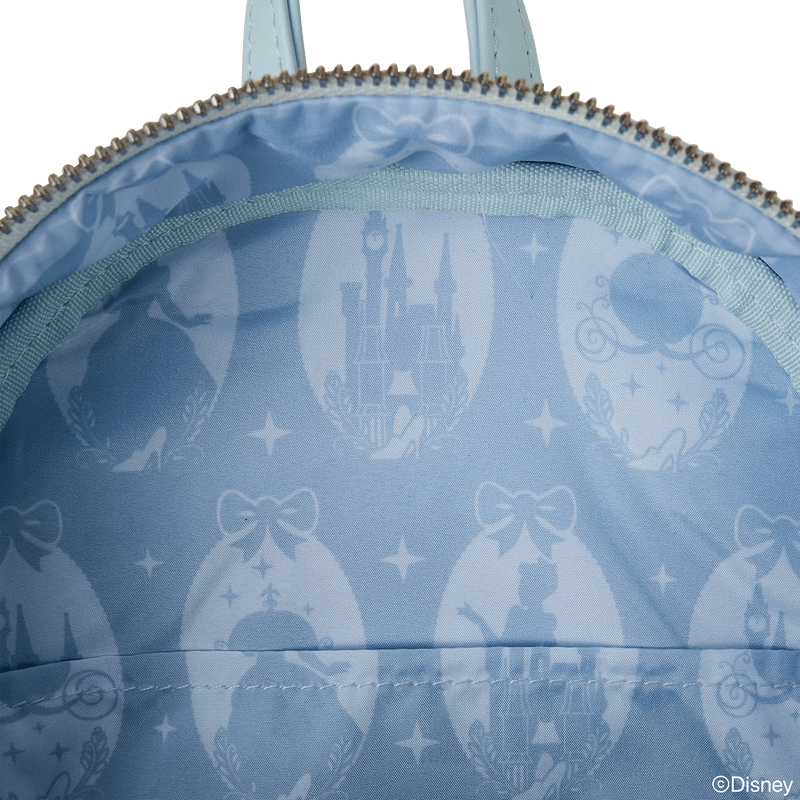 Interior lining of Cinderella Loungefly Back Pack bag with castle, carriage and slipper silhouettes on blue satin.	