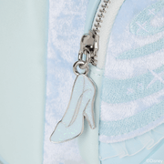 Close‑up of sparkling glass‑slipper zip charm on Cinderella Loungefly Back Pack bag.	