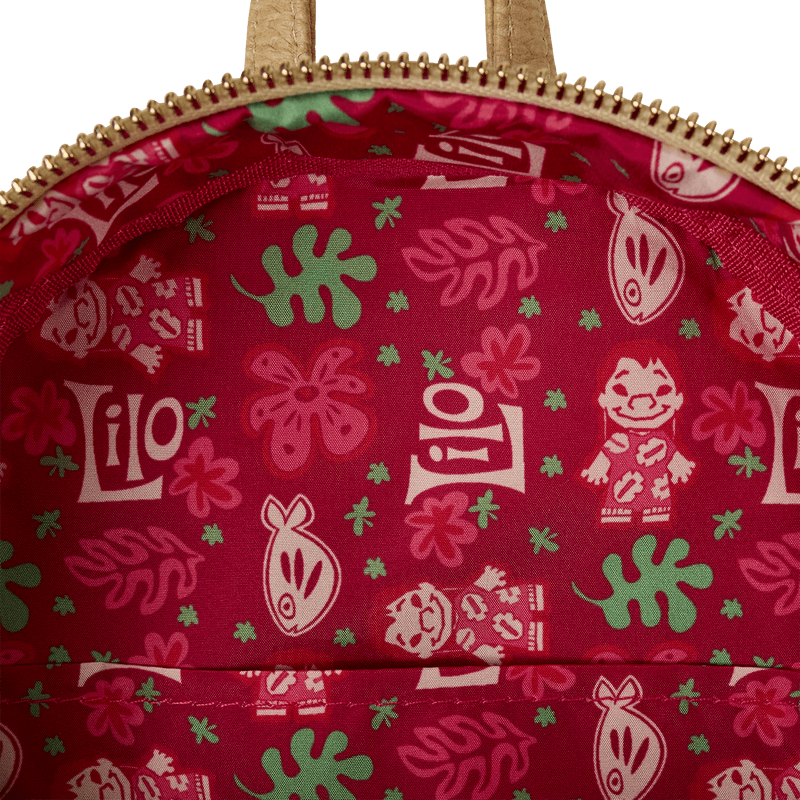 Tropical lining of Loungefly Lilo & Stitch Back Pack bag; red fabric with Lilo sketches, leaves and hibiscus motifs.	