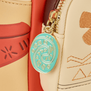 Close‑up of turquoise Heart of Te Fiti enamel zip charm on Moana Loungefly Back Pack bag.	