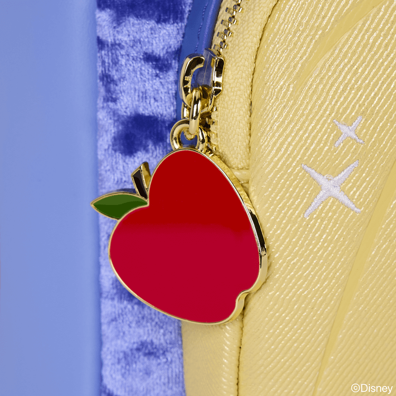 Close‑up of red enamel apple zip charm on Snow White Loungefly Back Pack bag.	