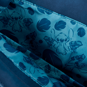 Close‑up of Loungefly Disney Stitch Back Pack bag lining featuring blue Stitch sketches and leaf motifs on satin fabric.	