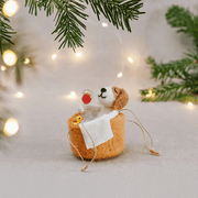 Dog in a bath felt hanging decoration displayed beside a Christmas tree