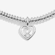 “Close‑up of two‑heart charm featuring ethical diamond accent”
