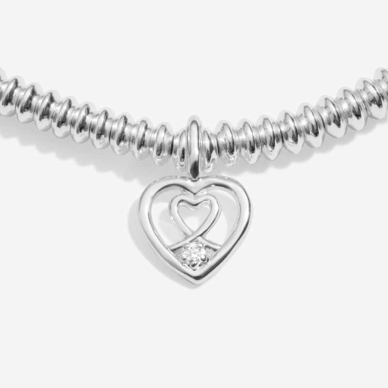 “Close‑up of two‑heart charm featuring ethical diamond accent”
