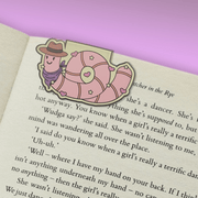 Earl the Worm magnetic bookmark clipped over a book page