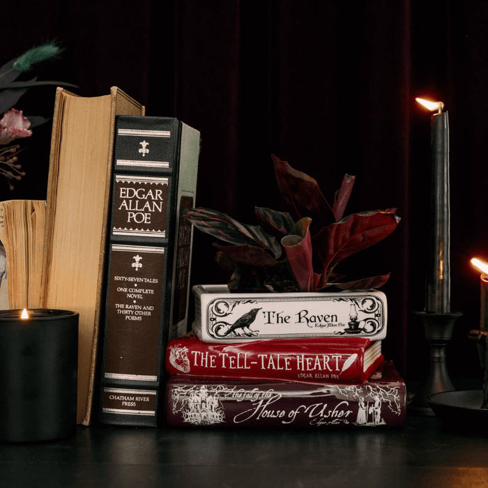 Edgar Allan Poe stacked books planter styled on a shelf with books and candles