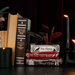 Edgar Allan Poe stacked books planter styled on a shelf with books and candles