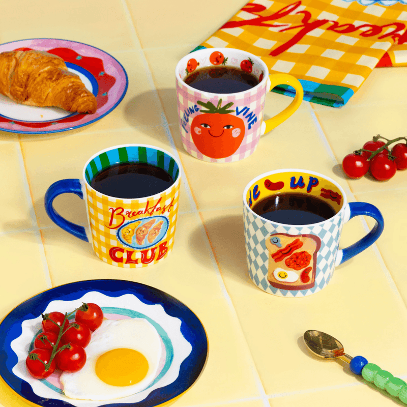Eleanor Bowmer Breakfast Club mug styled with breakfast food and colourful tableware