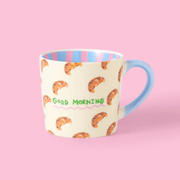 Eleanor Bowmer Good Morning Croissant mug with cream finish and blue handle