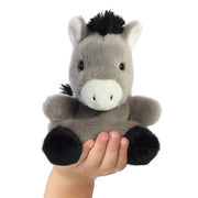 Eli Donkey Palm Pals plushie sitting in a child’s hand, showing its 13 cm palm-sized scale
