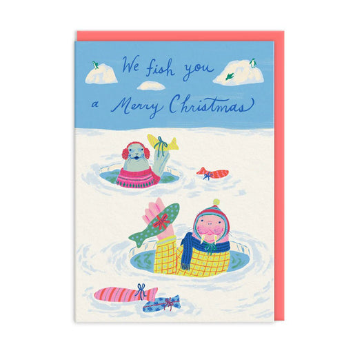 Christmas card with cosy seals popping from ice holes holding gift-wrapped fish; script reads We fish you a Merry Christmas; A6, blank inside, coral envelope by Emily Taylor