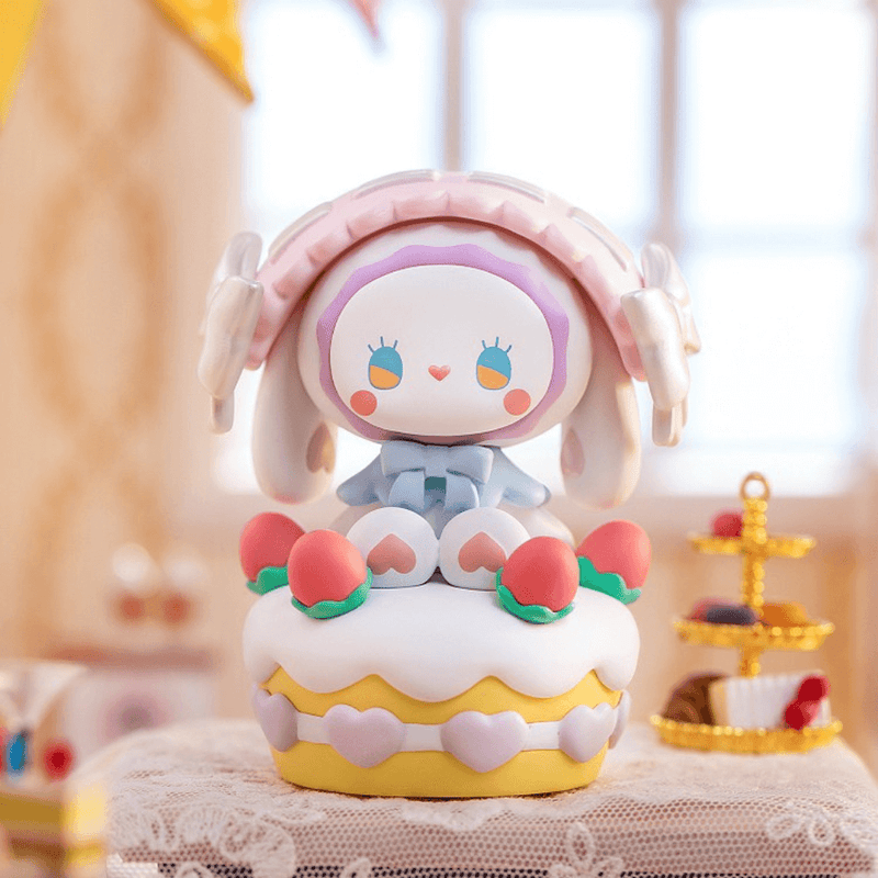 “Emma’s Birthday Cake” figure – bunny atop strawberry shortcake with pink hearts

