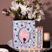 Emma ceramic book vase filled with white and pink blooms on a dressing table

