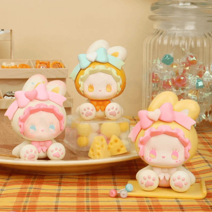 EMMA Bunny Collector Debut Series bunny figures in orange, pink and cream colourways on a dessert-themed set