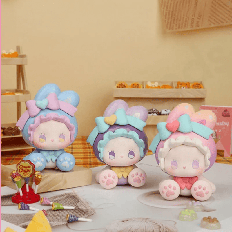Three EMMA Bunny Collector Debut Series pastel bunny figures displayed together on a dessert table