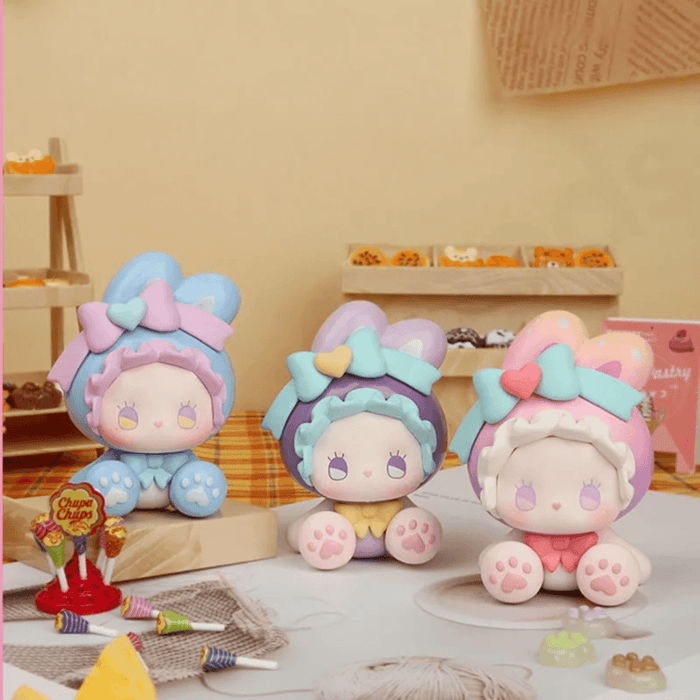 Three EMMA Bunny Collector Debut Series pastel bunny figures displayed together on a dessert table