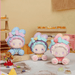 Three EMMA Bunny Collector Debut Series pastel bunny figures displayed together on a dessert table