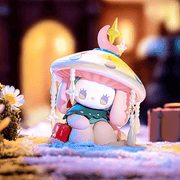 Traveler figure, wax‑draped bunny surrounded by candles, hearts and crystal accents
