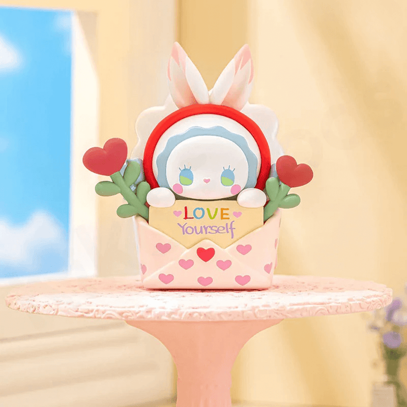 Love Letter bunny popping from heart-print envelope that reads “Love Yourself”
