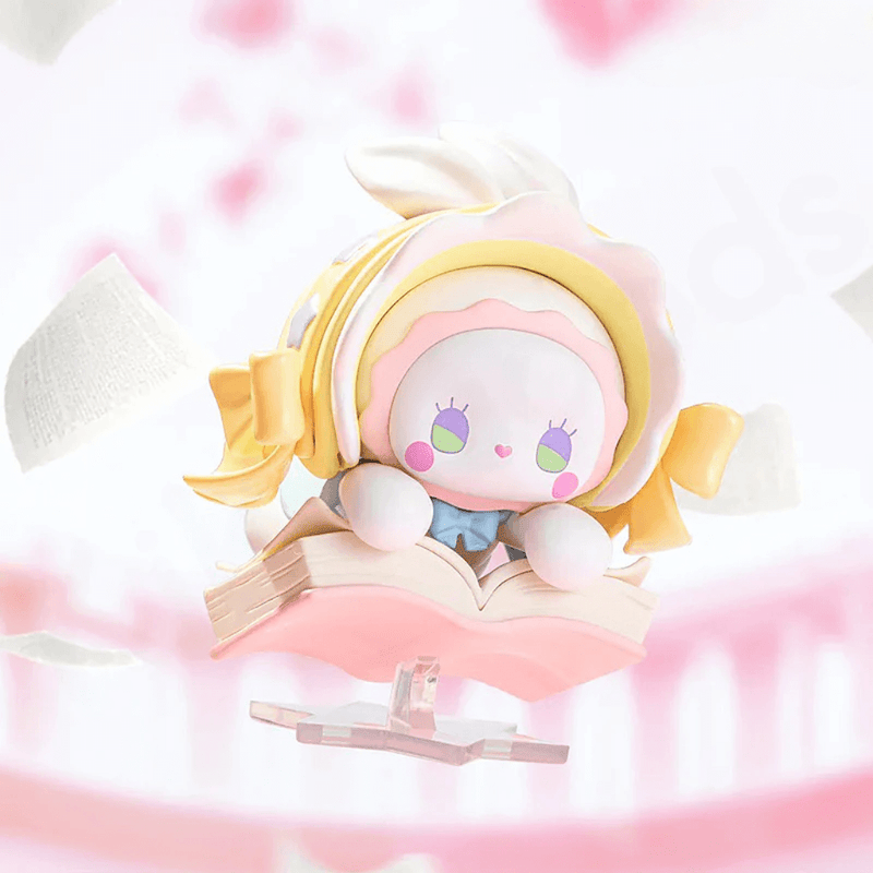 Reading World figure flying on open book with ribbon bow and flutter pages – Emma blind box
