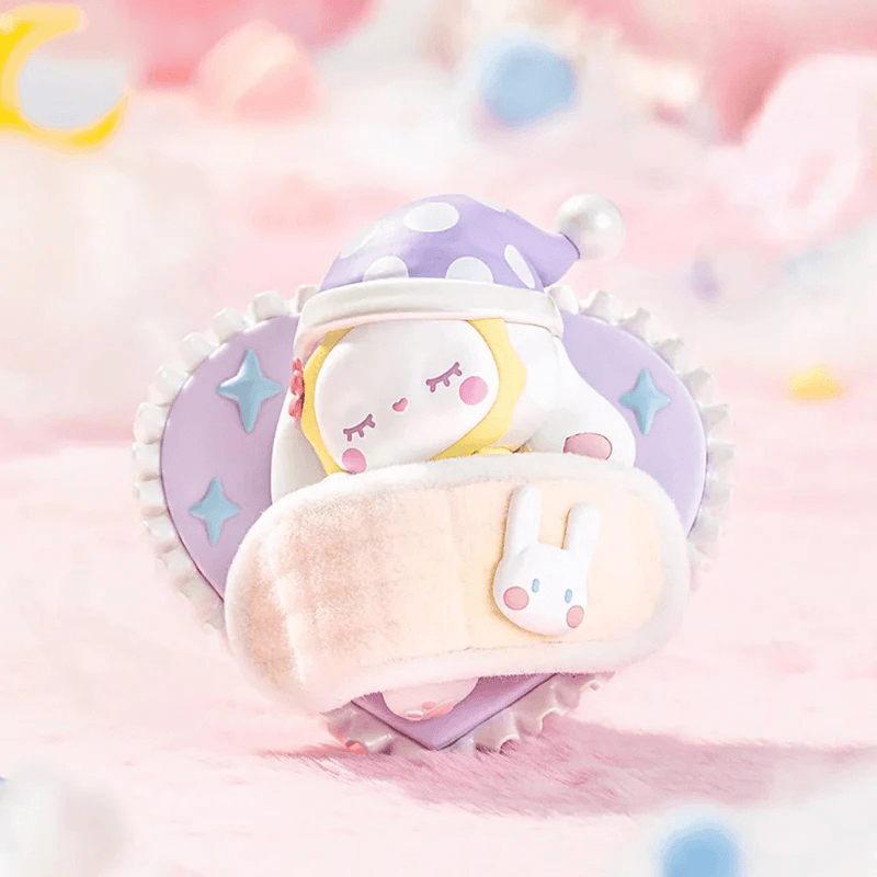 Sweet Dreams figure snoozing in lilac heart pillow with fuzzy eye mask – Emma Blind Box collectable
