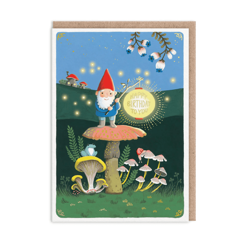 Enchanted gnome birthday greeting card with red-hat gnome on mushroom holding glowing lantern in night forest
