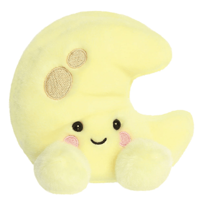 Evelyn Crescent Moon Palm Pals plush with smiling face, pink cheeks, embroidered crater details and soft yellow body.