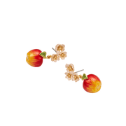 Pair of Fable England gold apple earrings lying at an angle showing painted yellow and red fruit details