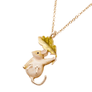 Close-up of hand-painted dormouse pendant with pink ears, black eyes, curled tail and golden-green oak leaf