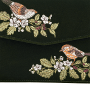 Close-up of two embroidered wrens surrounded by white blossoms, green leaves and dark blackberries