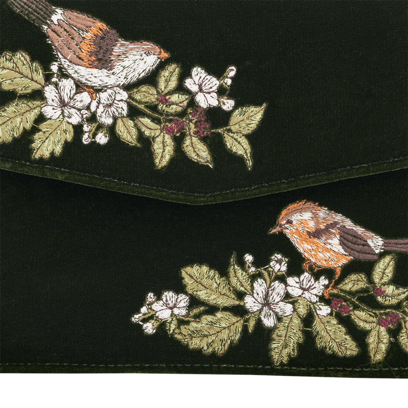 Close-up of two embroidered wrens surrounded by white blossoms, green leaves and dark blackberries
