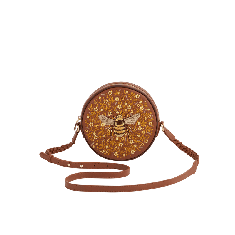 Fable England tan round crossbody bag with embroidered bumblebee, golden flowers and plaited shoulder strap