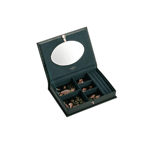 Open Fable England large forest-green jewellery box showing woodland embroidery, mirror, compartments and ring holders