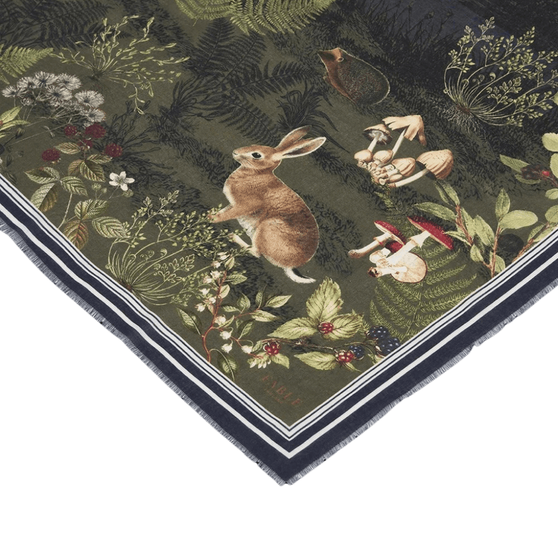 Close-up of Fable England navy Woodland Meadow scarf featuring a rabbit, mushrooms, flowers and forest foliage