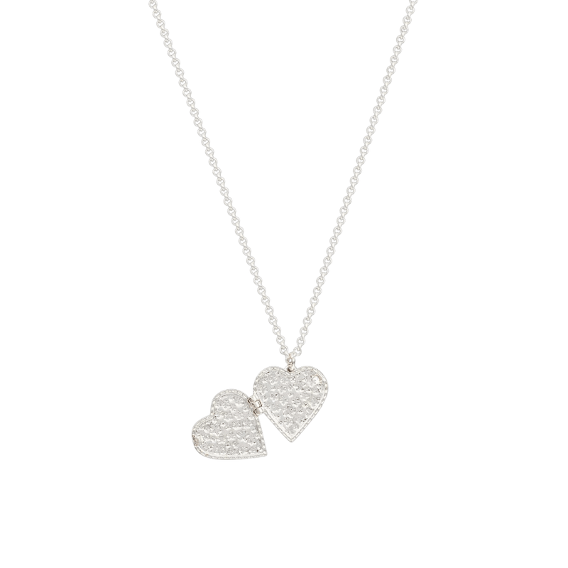 Open silver heart locket necklace showing two hinged compartments for treasured photographs