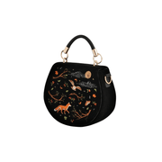Angled view of black embroidered Fable England handbag showing curved sides, fox and owl motif