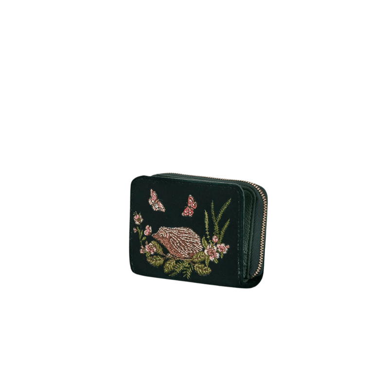 Angled view of small forest-green velvet hedgehog purse showing its gold zip and compact shape