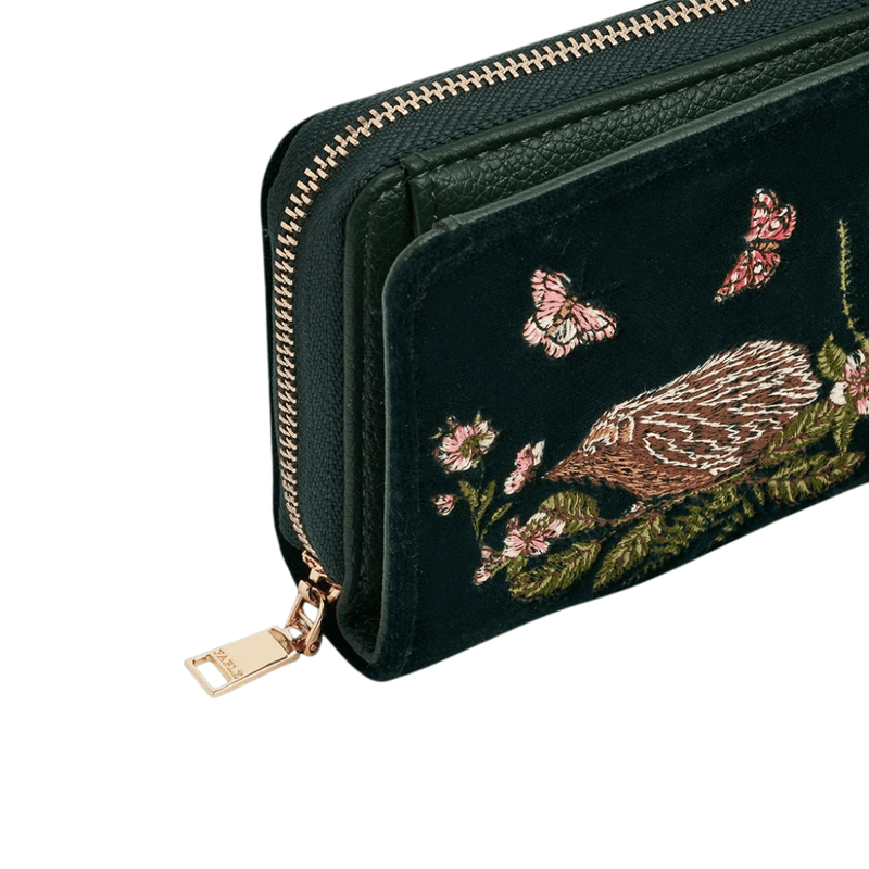 Close-up of Fable England hedgehog purse showing gold-toned zip, green trim and detailed woodland embroidery